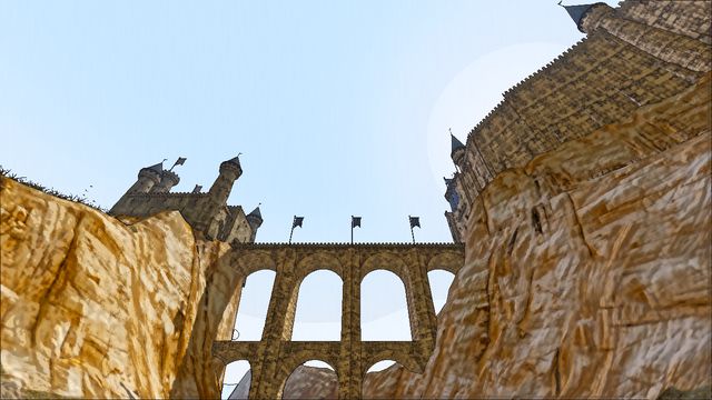 A stone viaduct of tall arches spanning a gorge below the city walls